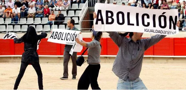 Activistas de Igualdad Animal saltan al ruedo llevando carteles con la palabra ABOLICION en protesta contra los toros
