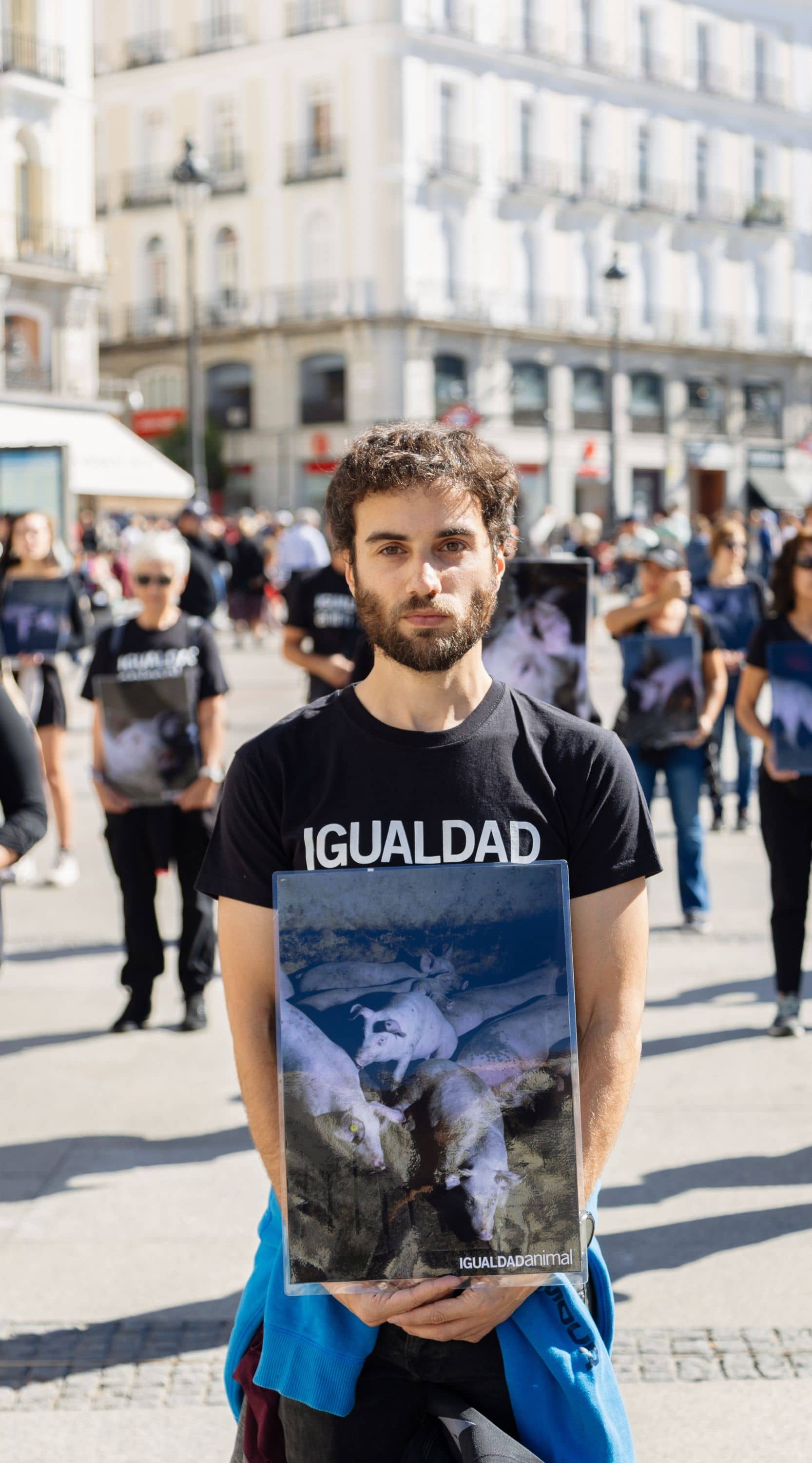 Activista sosteniendo una pancarta en protesta de Igualdad Animal en la Puerta del Sol en Madrid.